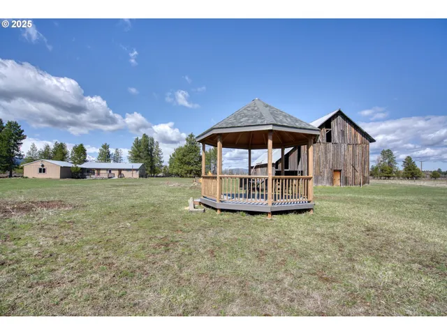 a view of a house with yard and a garden