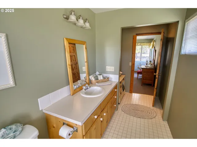 a bathroom with a sink mirror and vanity