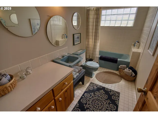 a view of a swimming pool with a table and chairs under an umbrella