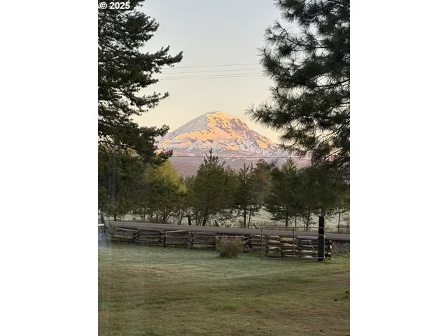 an aerial view of a house with table and chairs