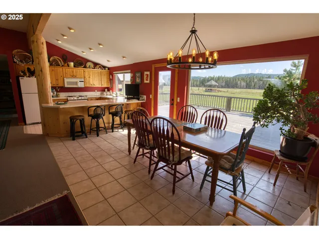 a view of a dining room with furniture and chandelier