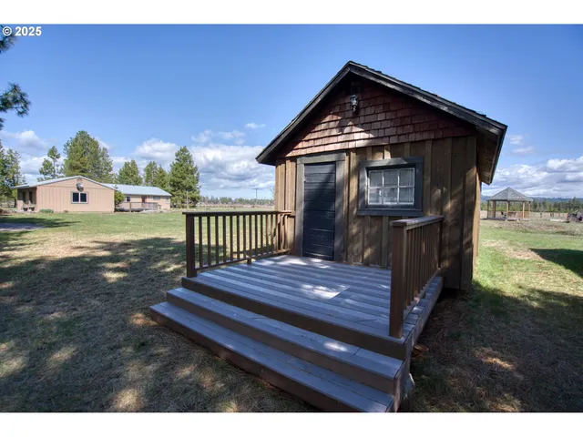 a view of a house with a yard and sitting area