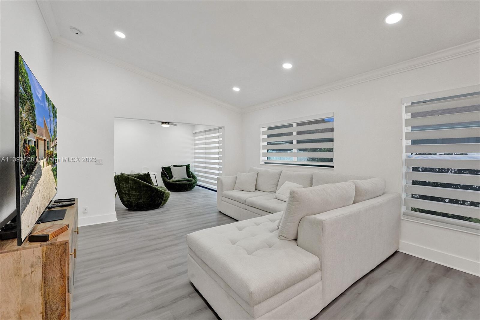 8201 Springtree Road, Unit 8201 Boca Raton, FL 33496 - Photo 13 of 54 a living room with furniture and a flat screen tv