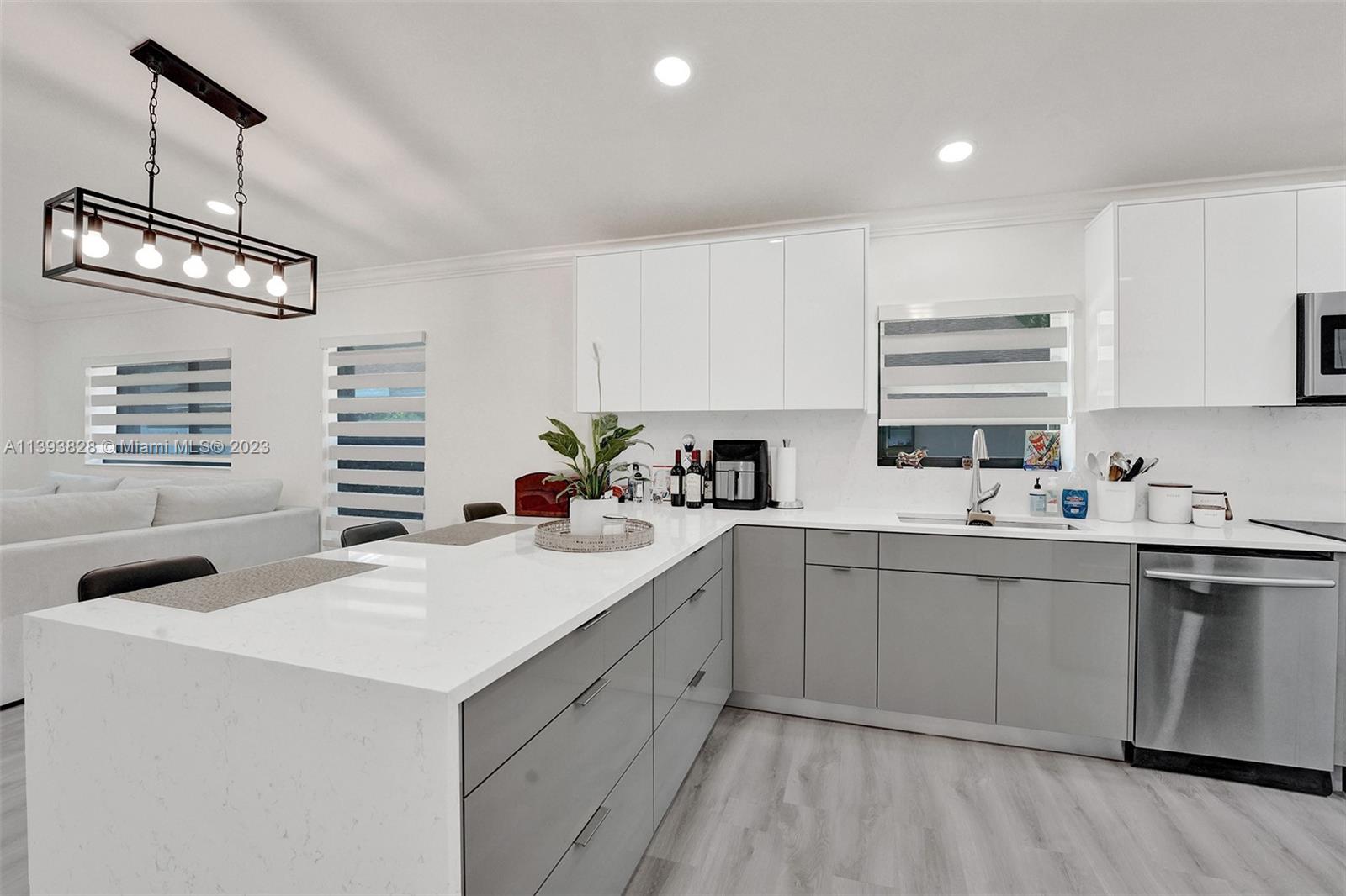 8201 Springtree Road, Unit 8201 Boca Raton, FL 33496 - Photo 5 of 54 a kitchen with a sink stove and cabinets