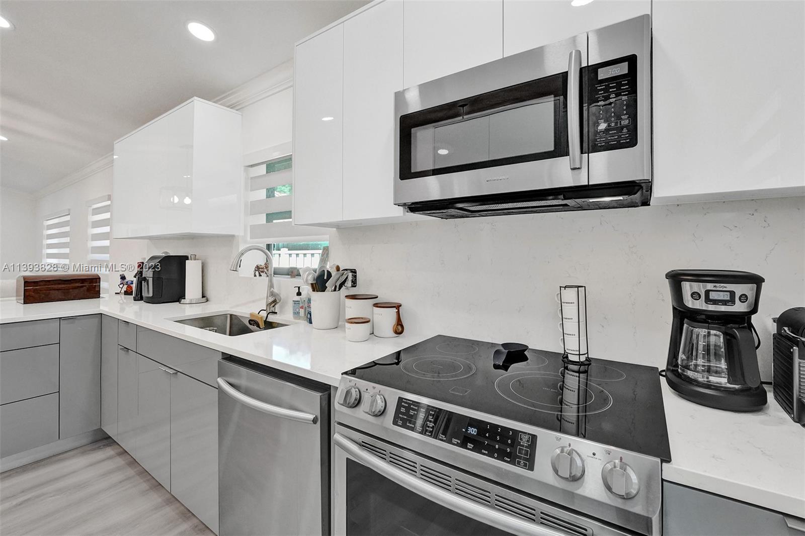 8201 Springtree Road, Unit 8201 Boca Raton, FL 33496 - Photo 8 of 54 a kitchen with a stove and a microwave