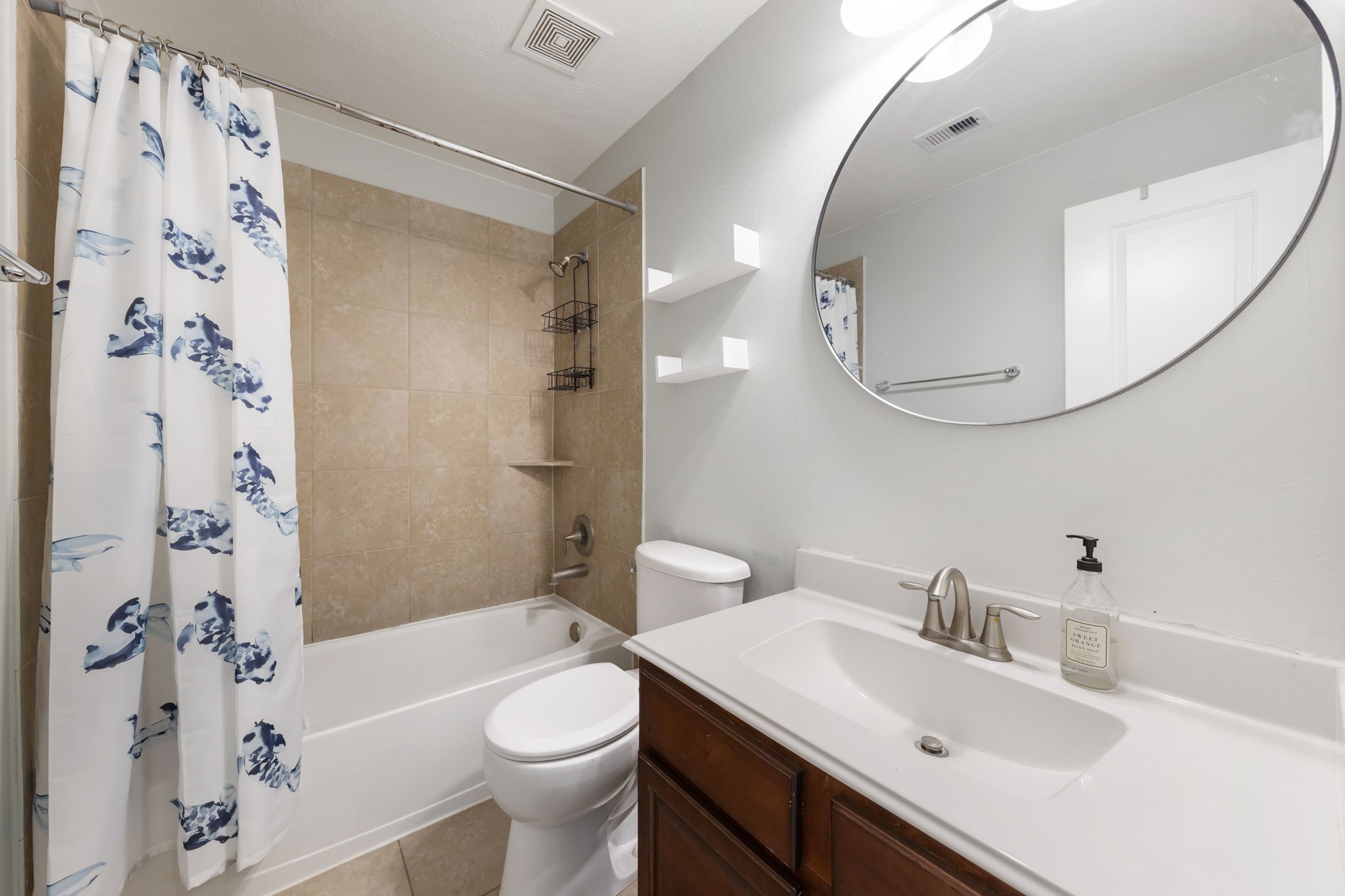 3318 Solvista High Court Spring, TX 77386 - Photo 24 of 33 Stylish secondary bath features a spacious vanity, tub and shower combination with tile surround, contemporary finishes, and a functional layout for family and guests.
