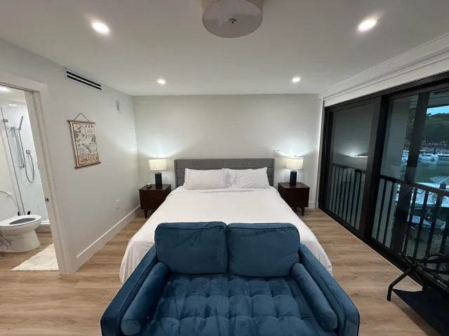 a bedroom with a bed and a flat screen tv