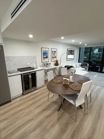 a living room with furniture and a kitchen view