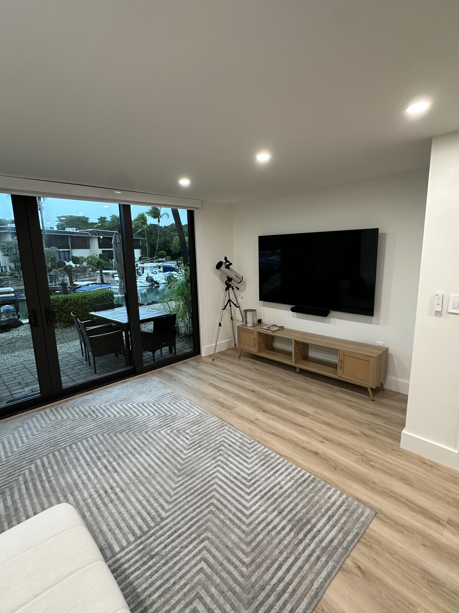 96000 Overseas Highway, Unit C7 Key Largo, FL 33037 - Photo 5 of 14 a living room with furniture flat screen tv and a floor to ceiling window