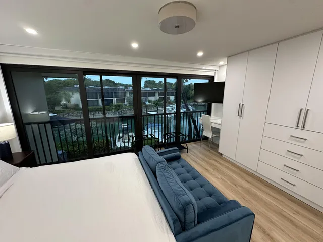 a bed sitting in a room next to a lamp