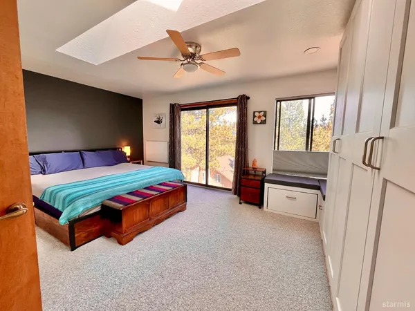 a bedroom with a bed dresser and window