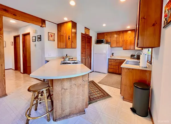 a kitchen with a sink appliances and cabinets