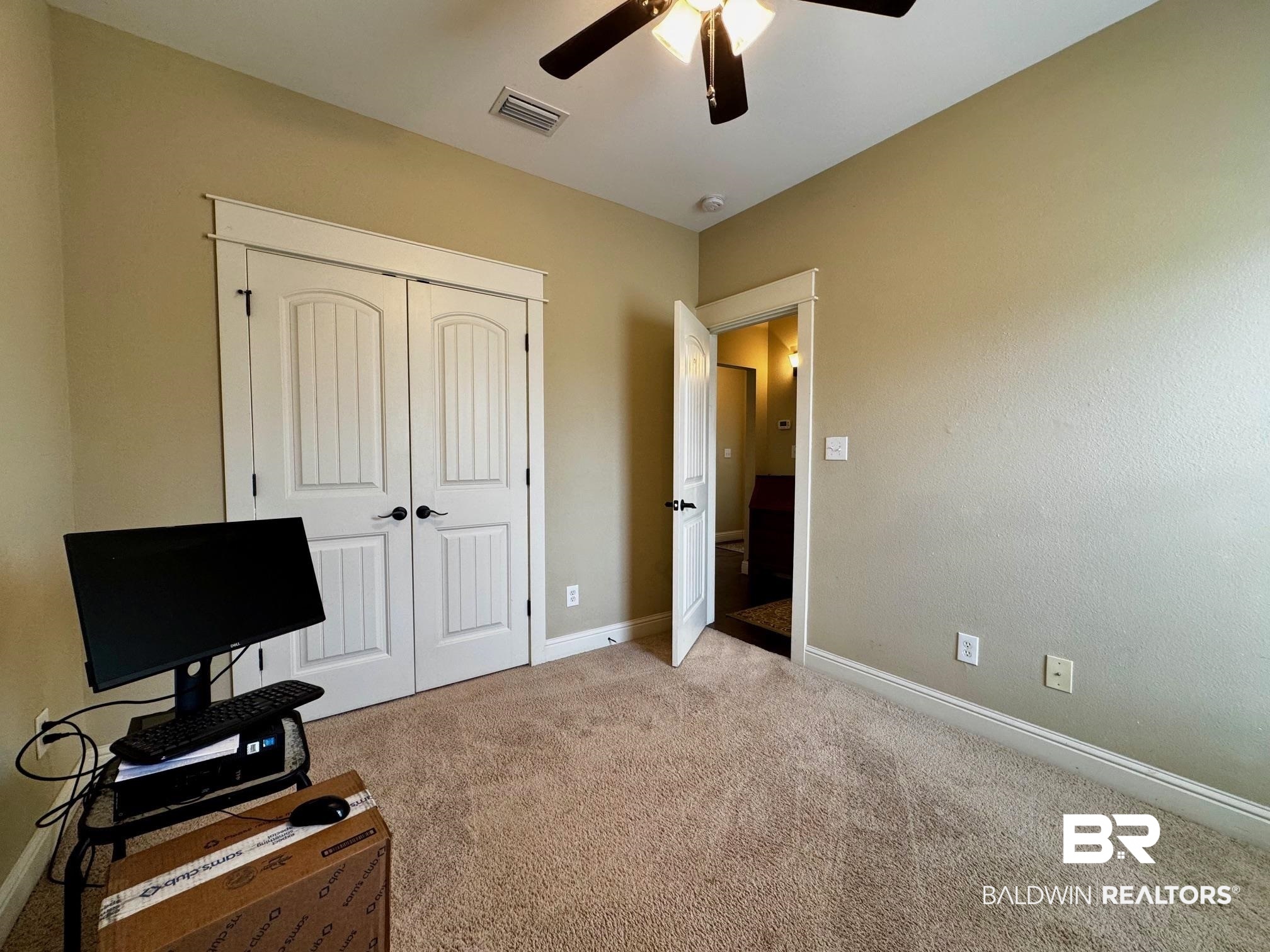 1030 Crown Walk Drive Foley, AL 36535 - Photo 26 of 40 Interior space featuring a ceiling fan, visible vents, baseboards, a closet, and light colored carpet