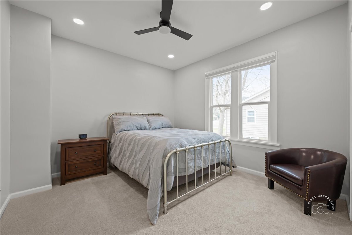 20 Central Avenue Aurora, IL 60506 - Photo 14 of 22 a spacious bedroom with a bed and a couch