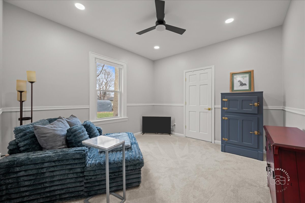 20 Central Avenue Aurora, IL 60506 - Photo 15 of 22 a spacious bedroom with a bed and a fireplace