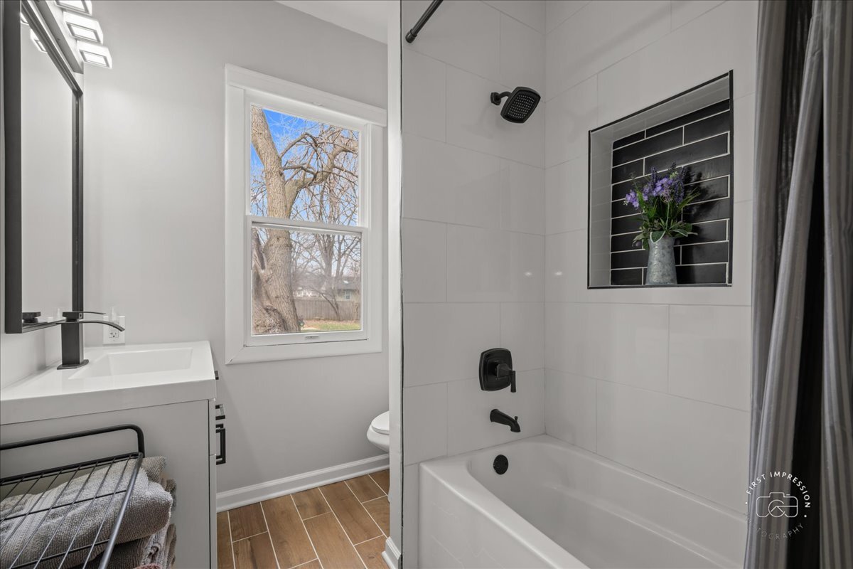20 Central Avenue Aurora, IL 60506 - Photo 17 of 22 a bathroom with a bathtub a shower and a sink