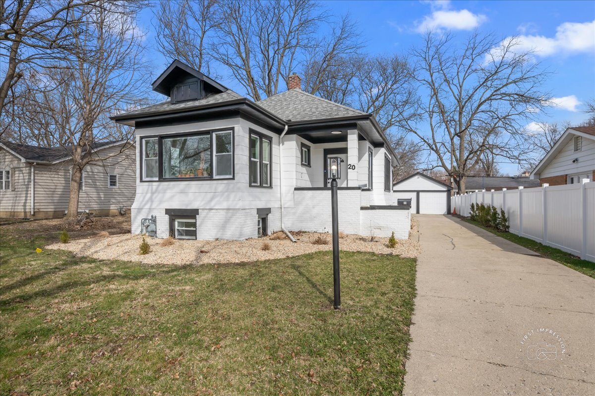 20 Central Avenue Aurora, IL 60506 - Photo 2 of 22 a front view of a house with a yard covered in snow