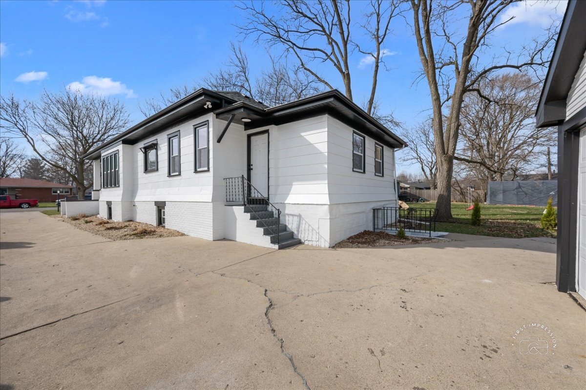 20 Central Avenue Aurora, IL 60506 - Photo 21 of 22 a front view of a house with a yard covered in snow