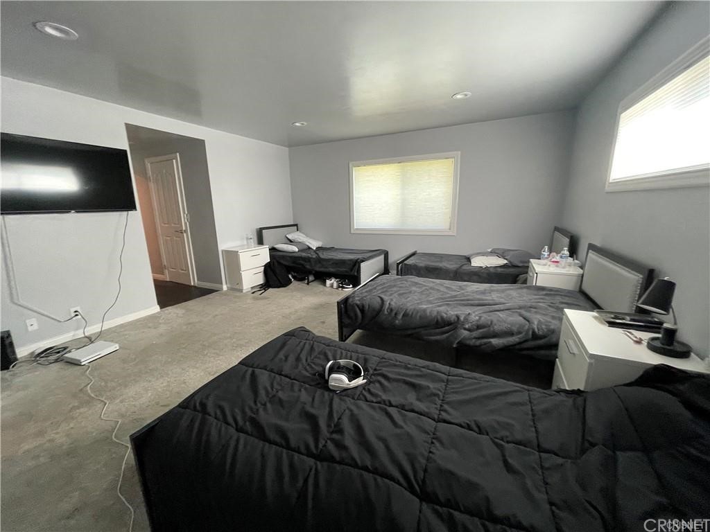 5259 Lewis Road Agoura Hills, CA 91301 - Photo 17 of 39 a bedroom with a bed and a television