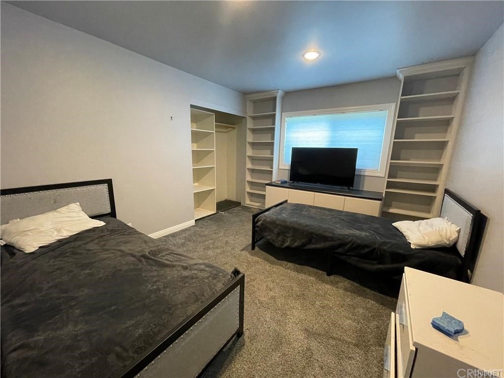 5259 Lewis Road Agoura Hills, CA 91301 - Photo 18 of 39 a bedroom with a bed and lamp