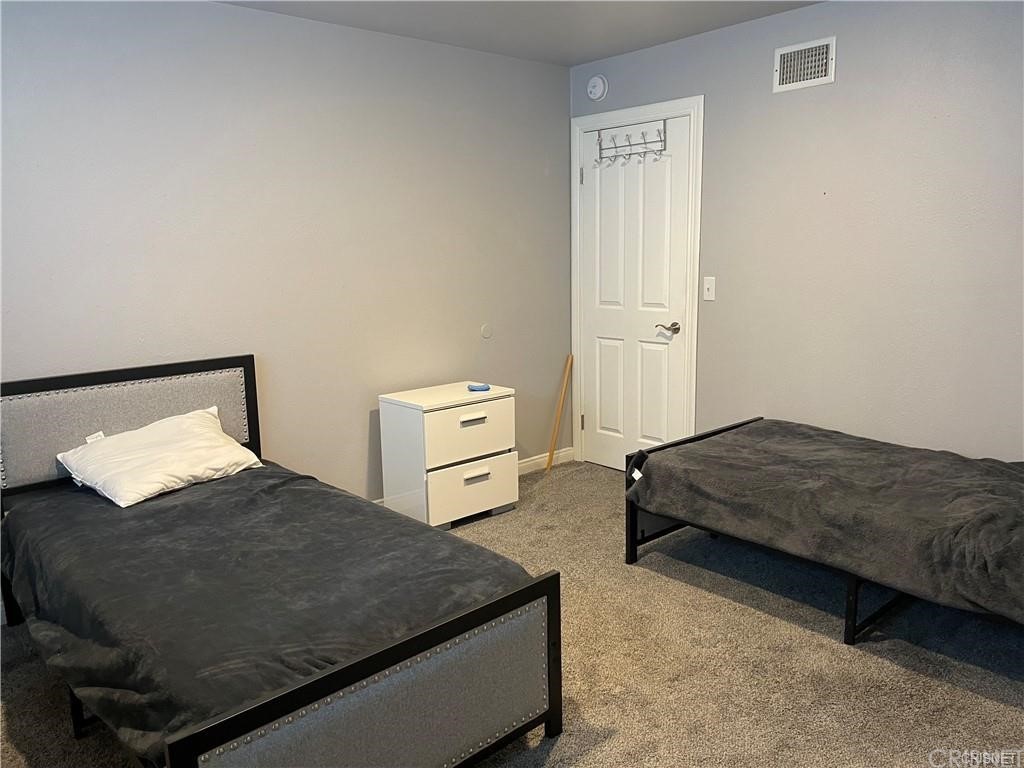 5259 Lewis Road Agoura Hills, CA 91301 - Photo 19 of 39 a bedroom with bed and flat screen tv
