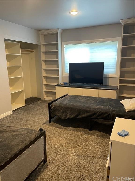 5259 Lewis Road Agoura Hills, CA 91301 - Photo 20 of 39 a bedroom with a bed and a flat tv screen