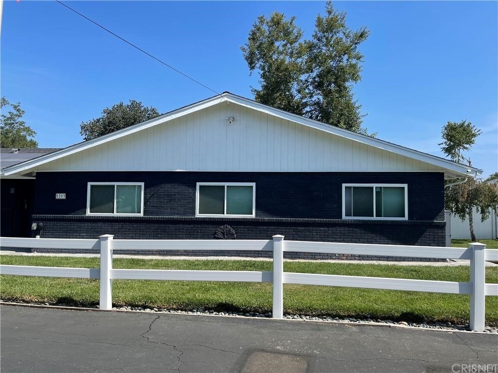 5259 Lewis Road Agoura Hills, CA 91301 - Photo 36 of 39 a view of a house with a yard and a garage