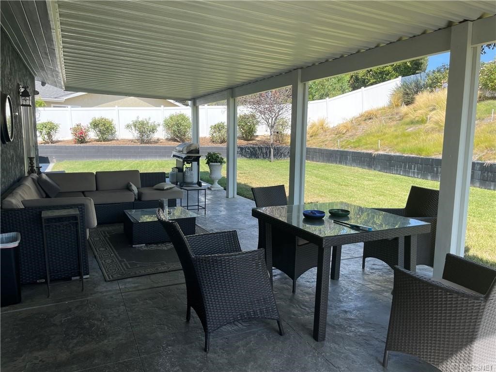 5259 Lewis Road Agoura Hills, CA 91301 - Photo 5 of 39 a living room with furniture and a floor to ceiling window