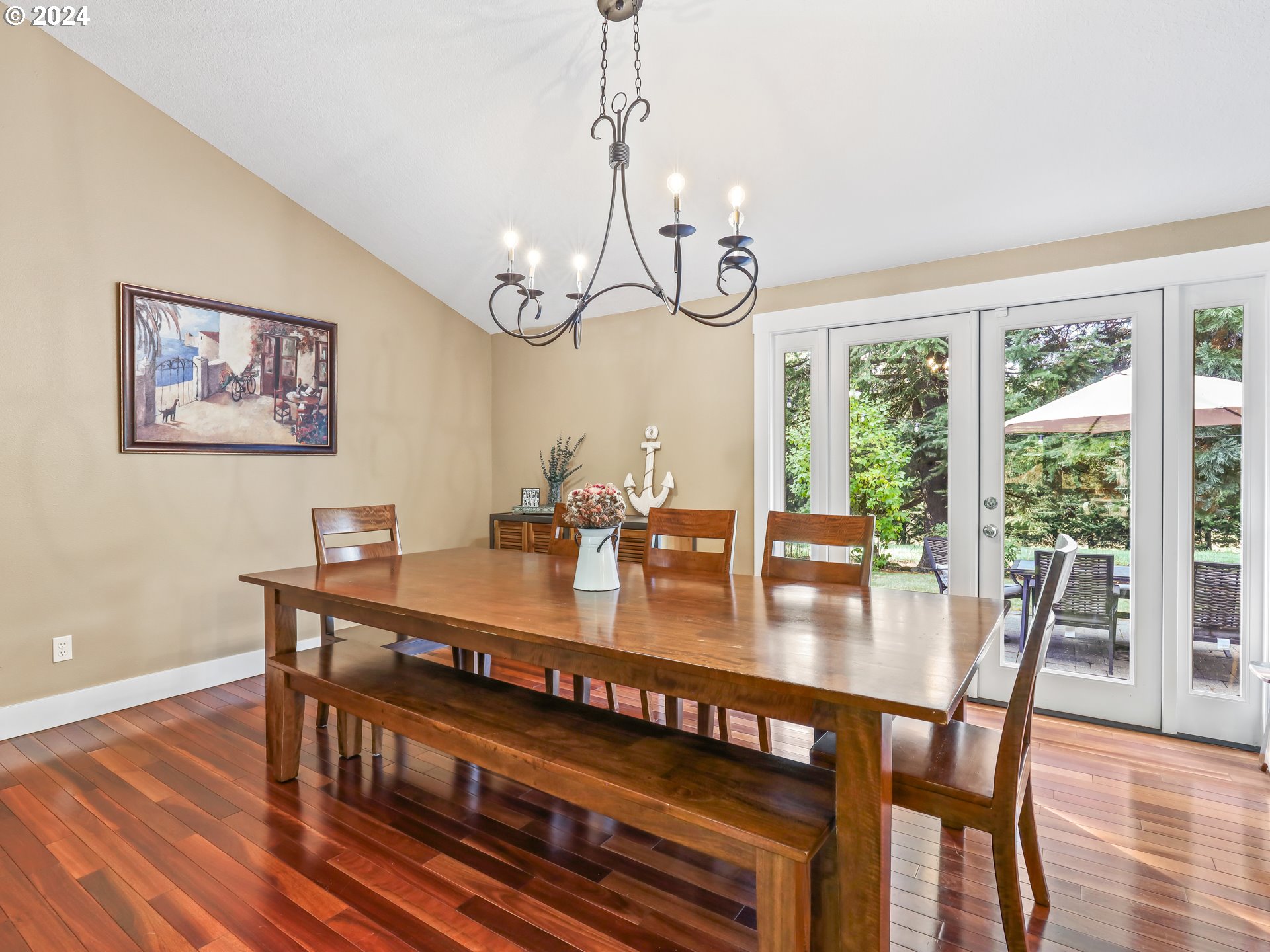 16787 Southeast Tong Road Damascus, OR 97089 - Photo 11 of 47 a view of a dining room and livingroom with furniture wooden floor a chandelier