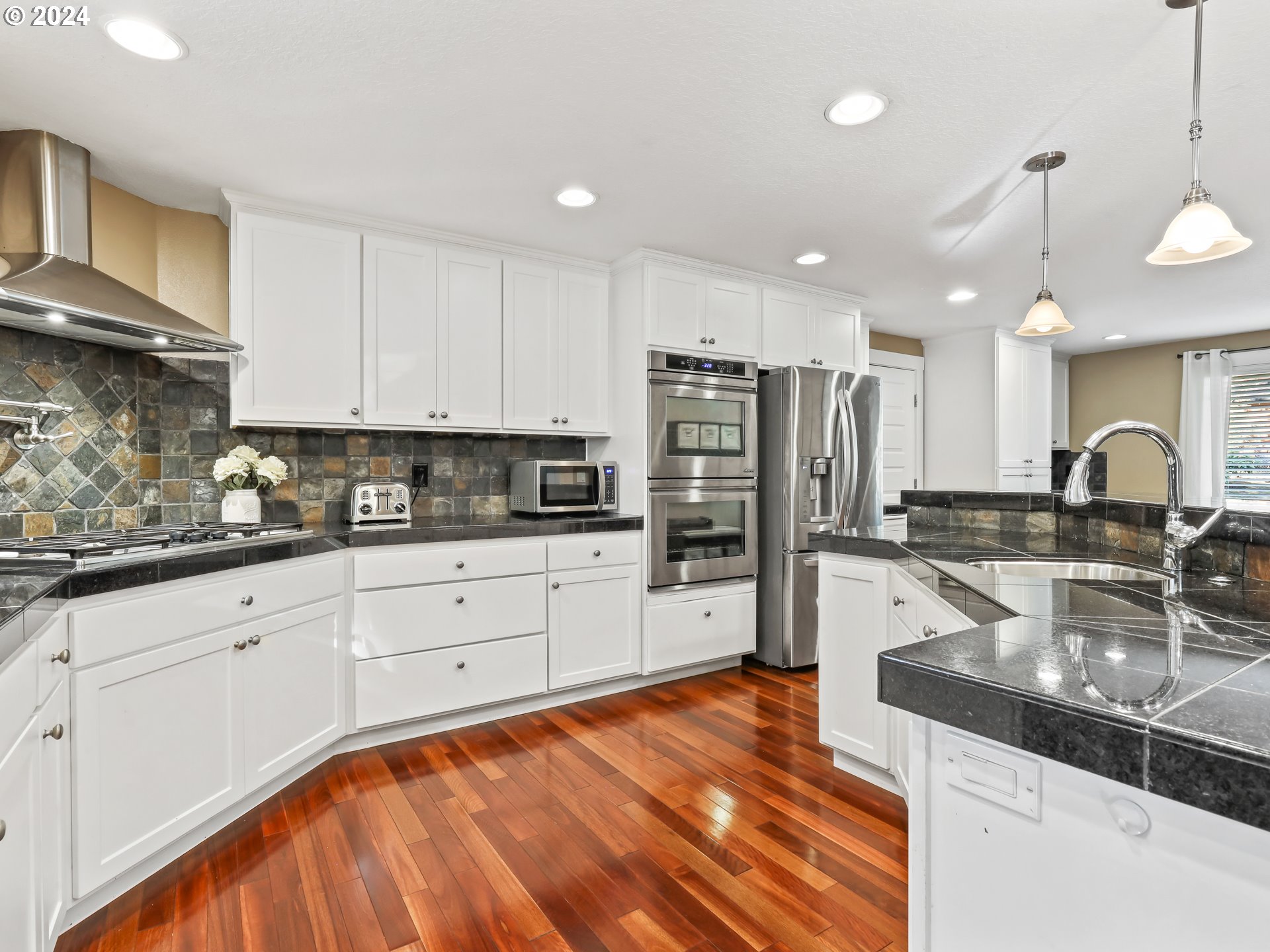 16787 Southeast Tong Road Damascus, OR 97089 - Photo 14 of 47 a kitchen with stainless steel appliances granite countertop a sink refrigerator and cabinets