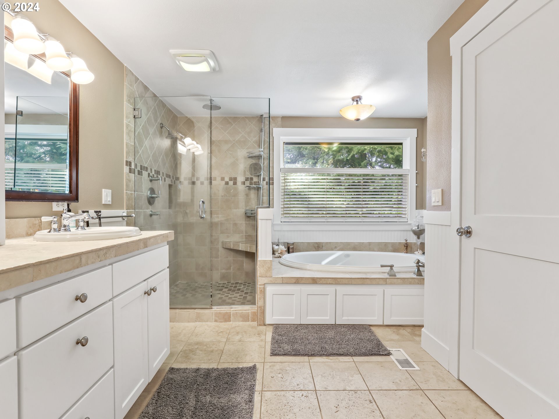 16787 Southeast Tong Road Damascus, OR 97089 - Photo 23 of 47 a bath room with a sink a large mirror and a bathtub