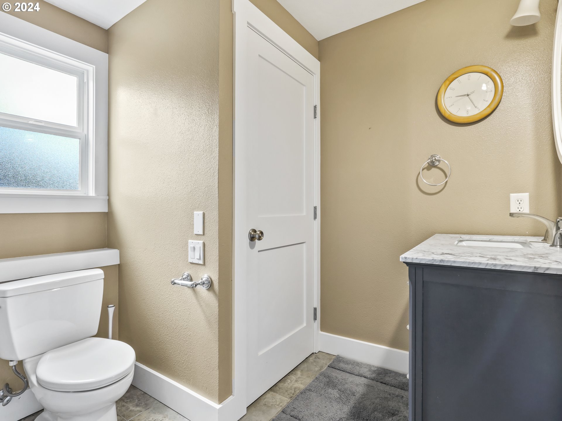 16787 Southeast Tong Road Damascus, OR 97089 - Photo 32 of 47 a bathroom with a granite countertop sink and a toilet
