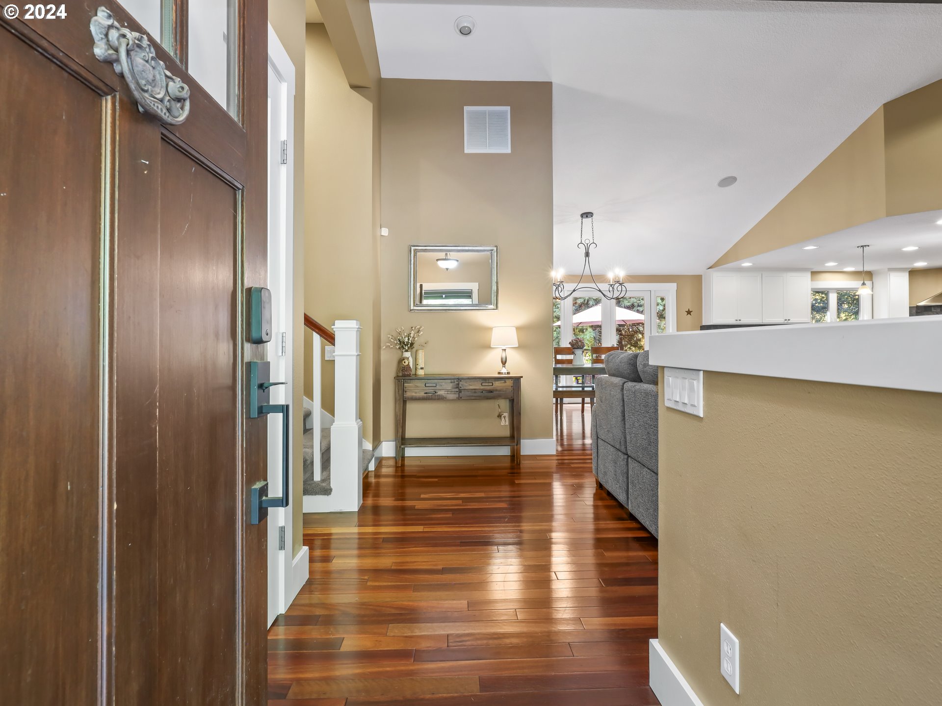 16787 Southeast Tong Road Damascus, OR 97089 - Photo 5 of 47 a view of a kitchen with kitchen island white cabinetry and wooden floor