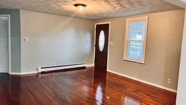 34 Border Street Springfield, MA 01104 - Photo 16 of 20 an empty room with wooden floor and windows
