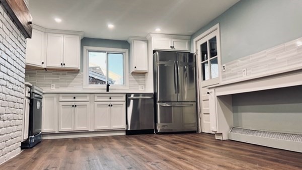 34 Border Street Springfield, MA 01104 - Photo 5 of 20 a kitchen with kitchen island a counter top space wooden floor cabinets and stainless steel appliances