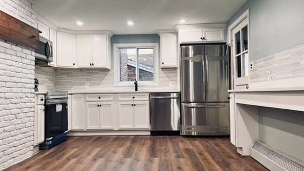 34 Border Street Springfield, MA 01104 - Photo 6 of 20 a kitchen with a refrigerator sink and cabinets
