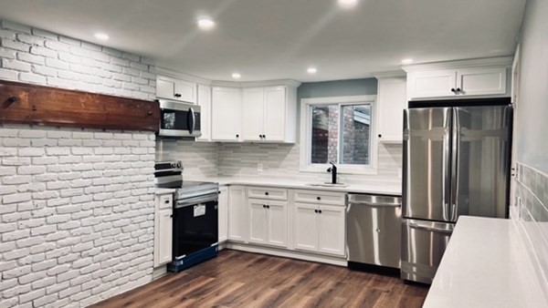 34 Border Street Springfield, MA 01104 - Photo 7 of 20 a kitchen with stainless steel appliances a refrigerator a sink a stove top oven a sink and cabinets