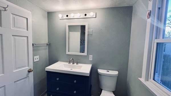 34 Border Street Springfield, MA 01104 - Photo 8 of 20 a bathroom with a toilet sink and mirror