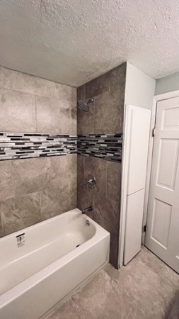 34 Border Street Springfield, MA 01104 - Photo 9 of 20 a bathroom with a tub a sink and a shower