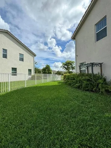 a view of a backyard with plants and a garden