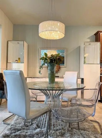 a view of a dining room with furniture and a chandelier