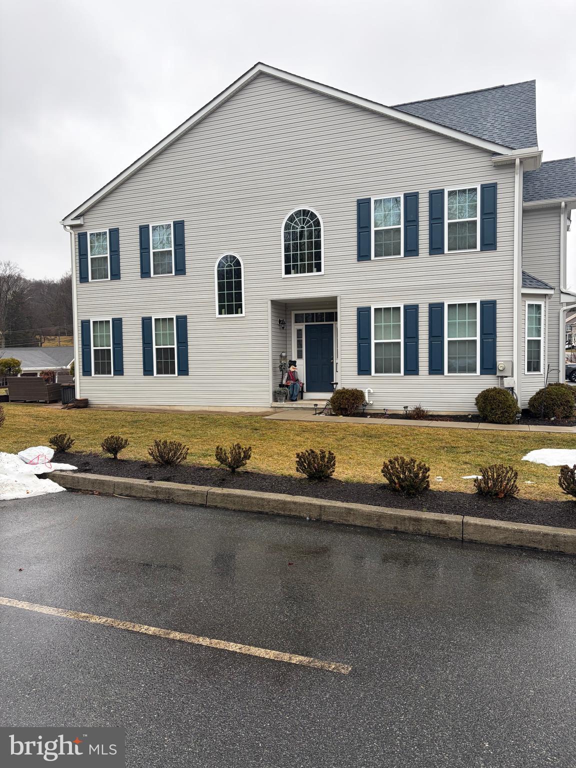 74 Emily Court Reading, PA 19606 - Photo 1 of 31 a front view of a house with swimming pool and trees in the background