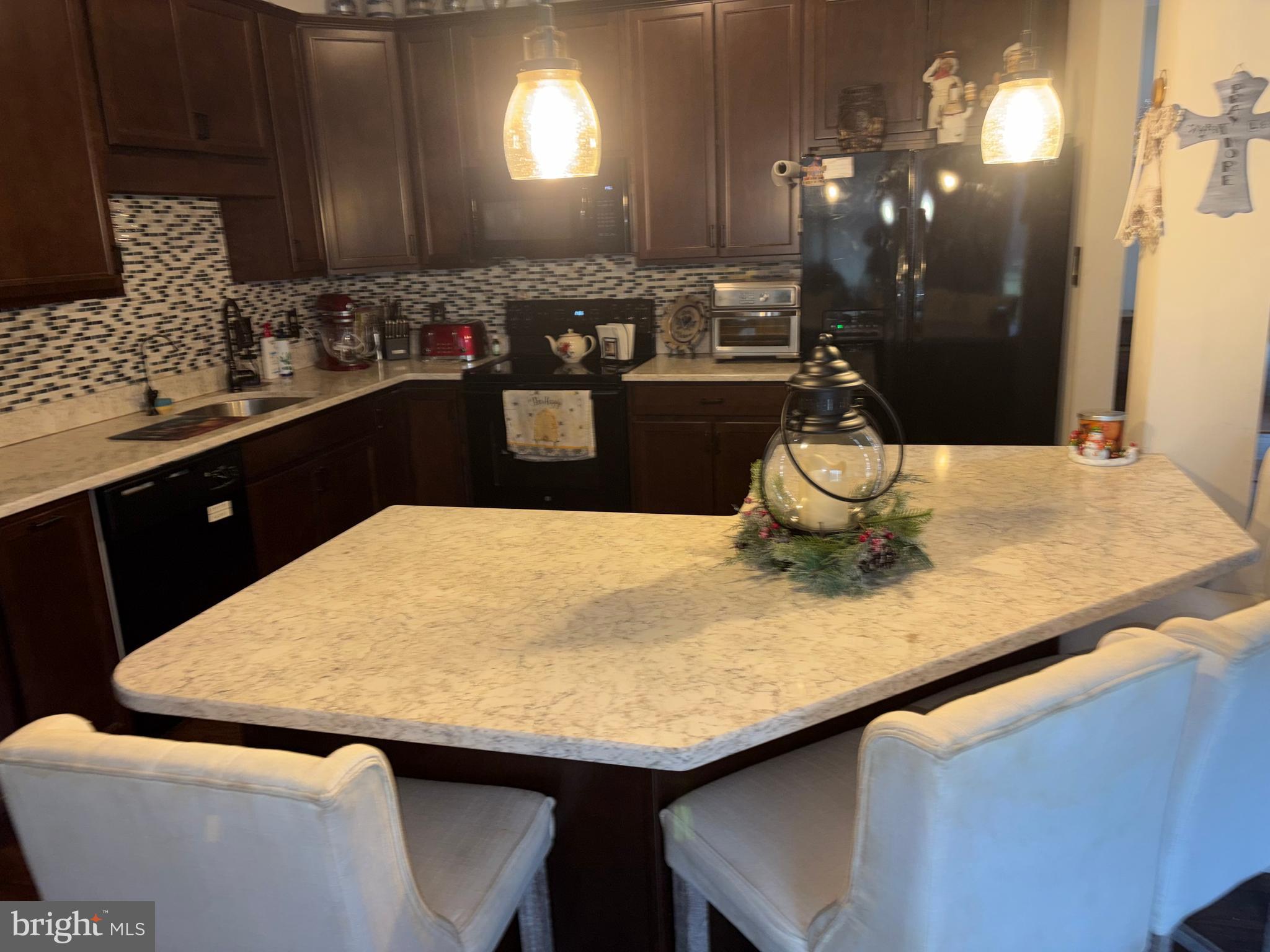 74 Emily Court Reading, PA 19606 - Photo 7 of 31 a kitchen with a sink a table and chairs