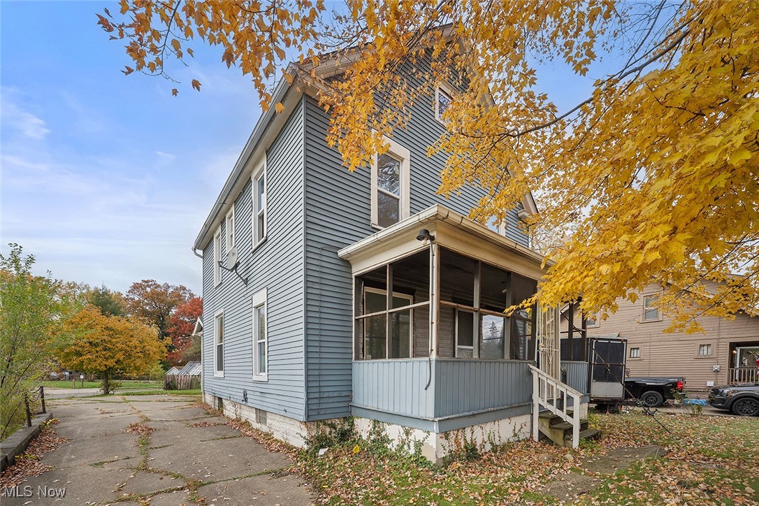 View of property exterior featuring a sunroom