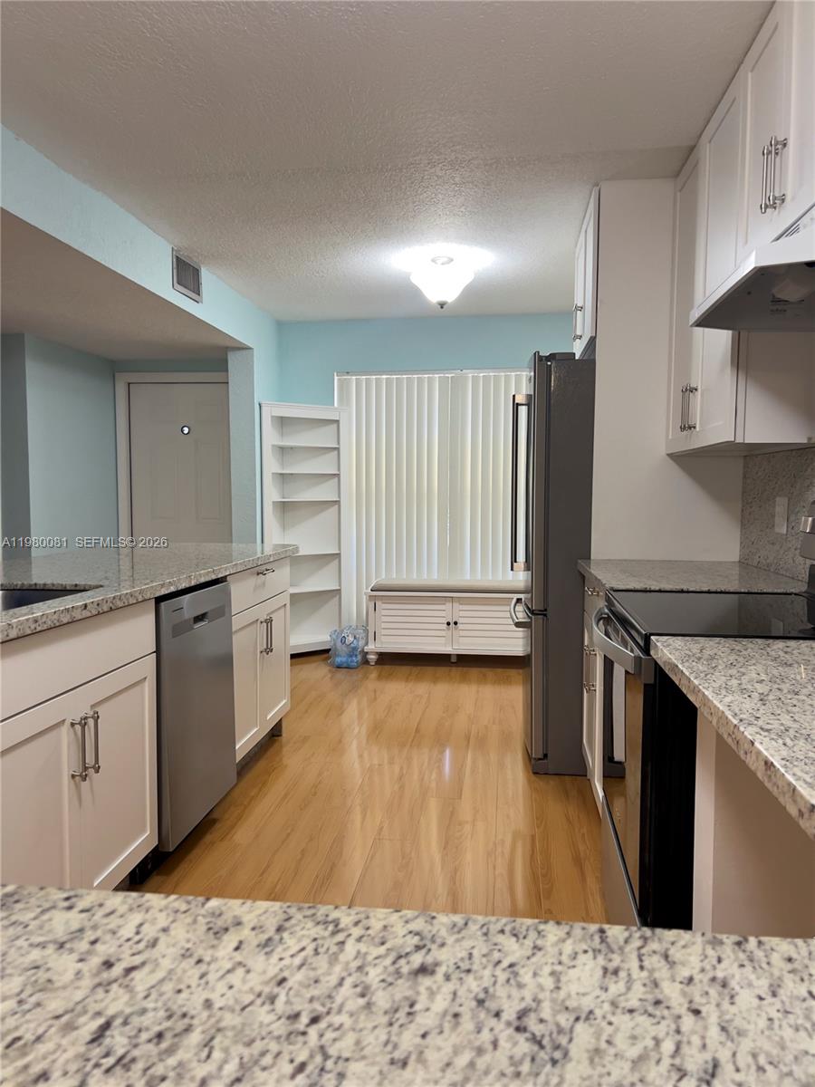 3302 Farragut Street, Unit 5F Hollywood, FL 33021 - Photo 2 of 11 a kitchen with stainless steel appliances granite countertop a sink stove and refrigerator