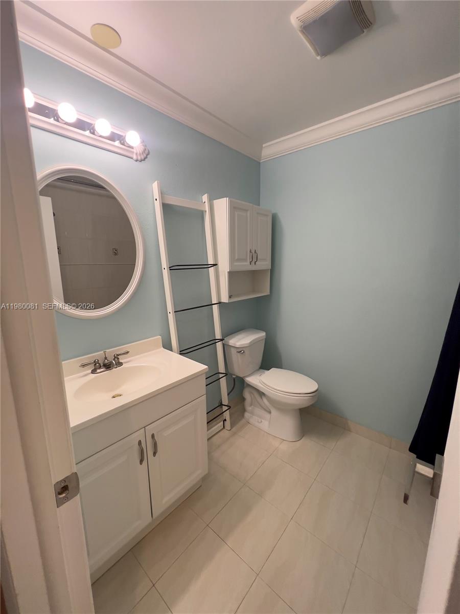 3302 Farragut Street, Unit 5F Hollywood, FL 33021 - Photo 5 of 11 a bathroom with a toilet sink and mirror