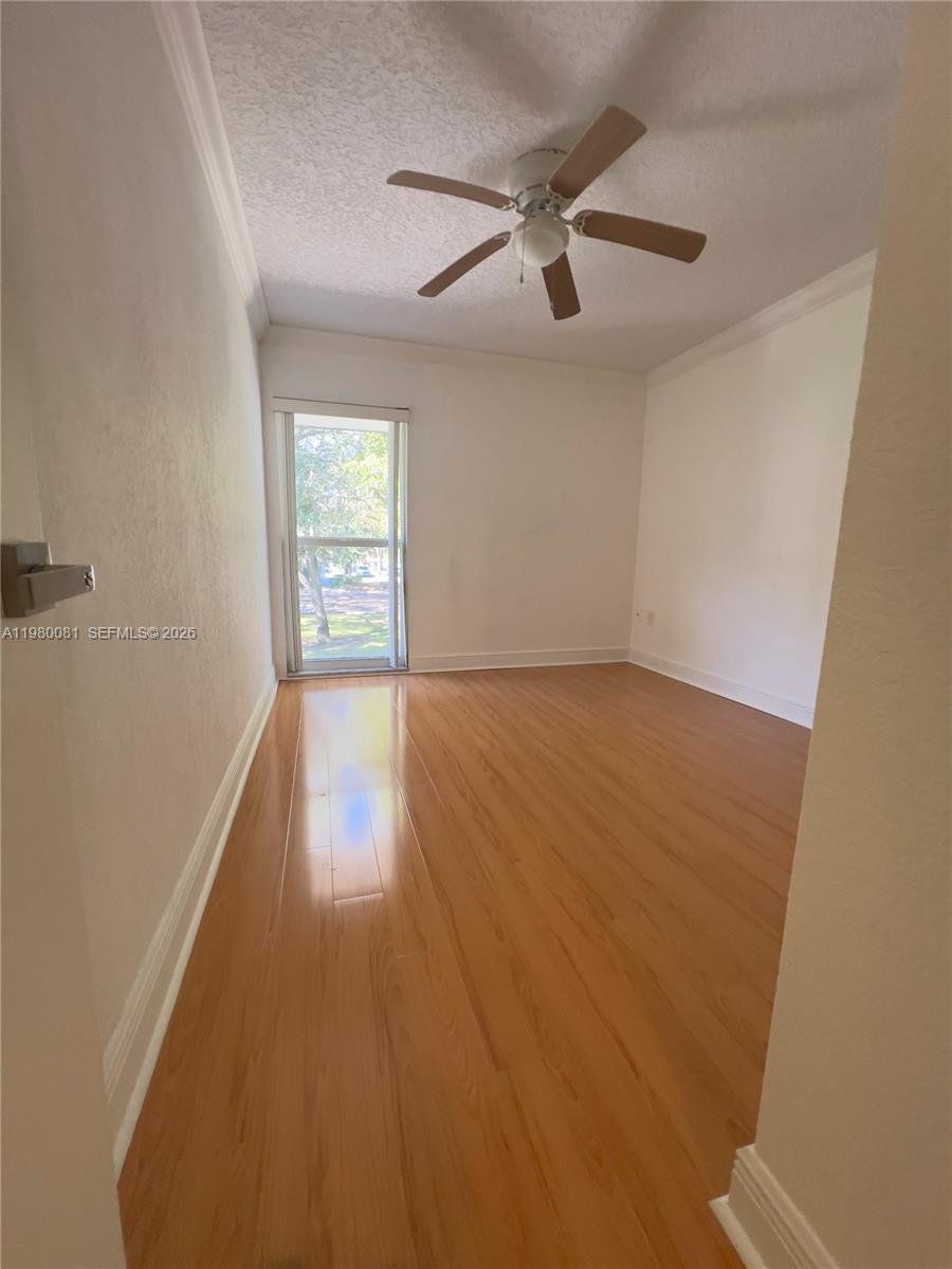 3302 Farragut Street, Unit 5F Hollywood, FL 33021 - Photo 7 of 11 wooden floor in an empty room with a window