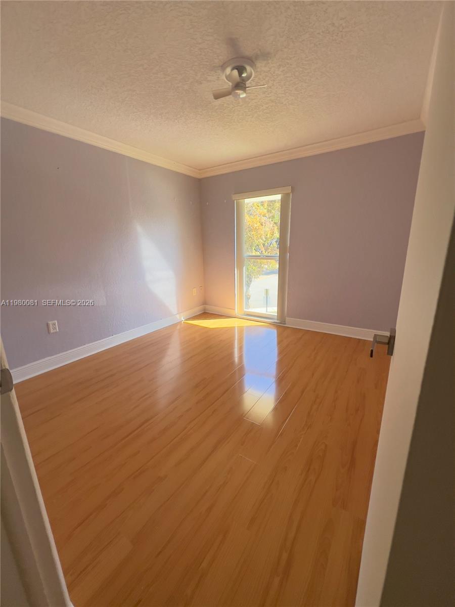 3302 Farragut Street, Unit 5F Hollywood, FL 33021 - Photo 8 of 11 wooden floor in an empty room with a window
