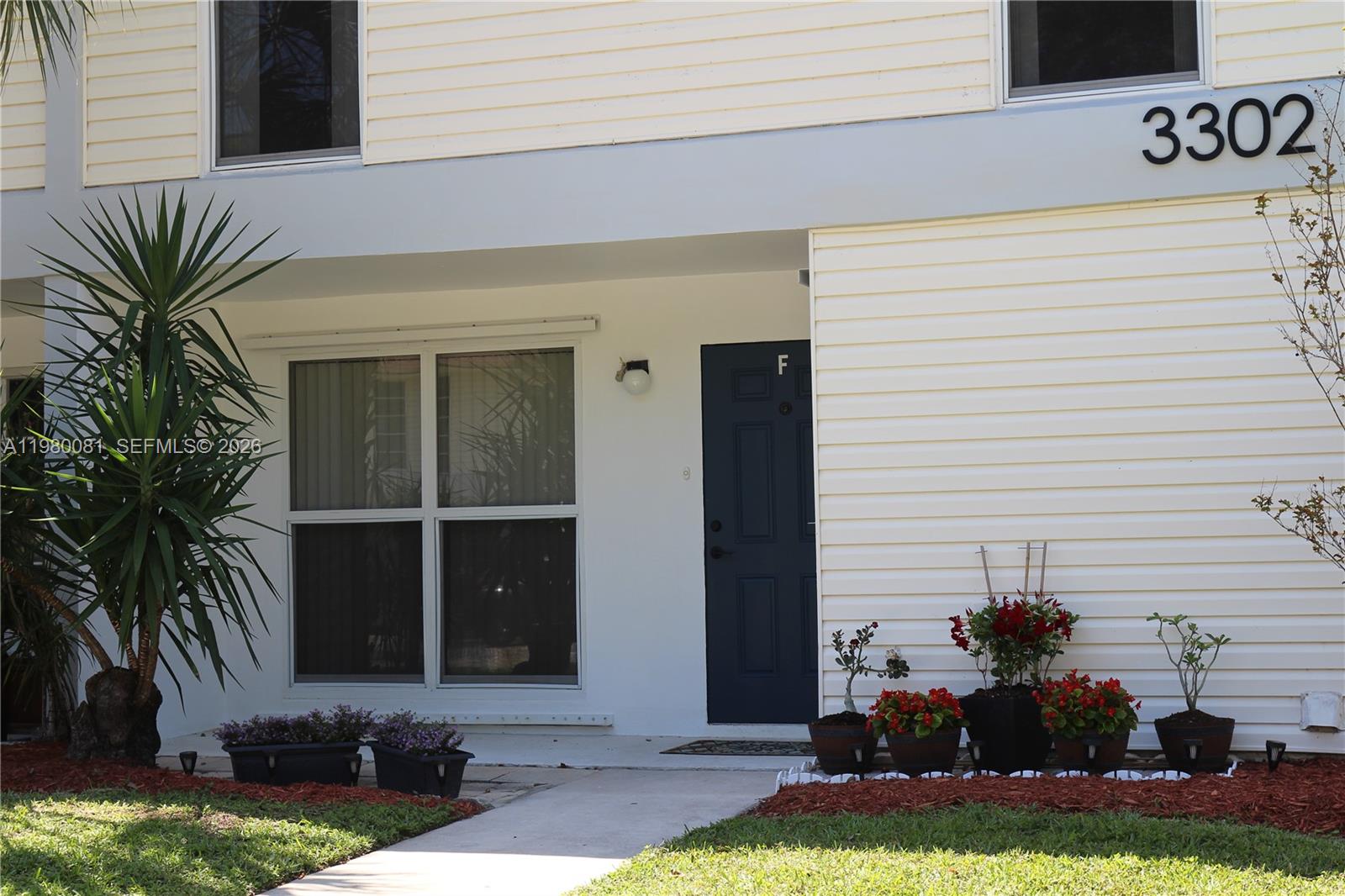 3302 Farragut Street, Unit 5F Hollywood, FL 33021 - Photo 10 of 11 a front view of a house with garden