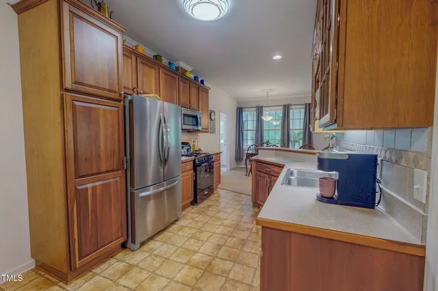 a view of backyard of house with outdoor seating and green space